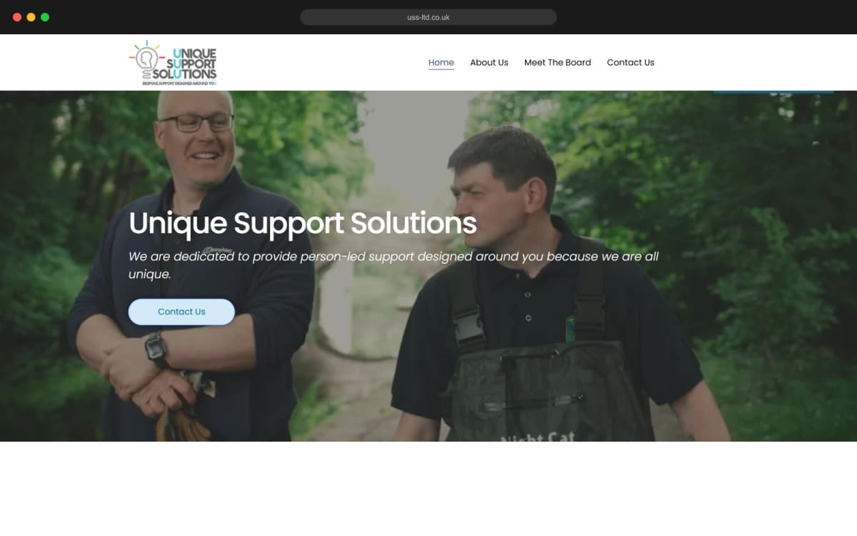 The Unique Support Solutions homepage: two men walking a wooded path together under the line 'person-led support designed around you'